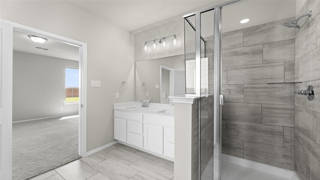 bathroom with tile patterned flooring, vanity, and a shower with door