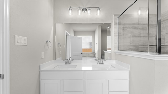 bathroom featuring vanity and tiled shower