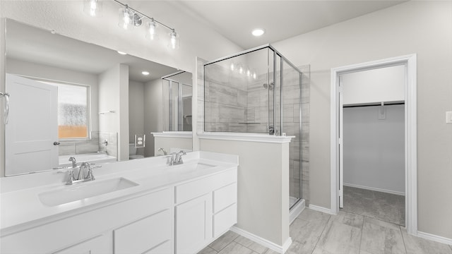 bathroom with vanity and separate shower and tub