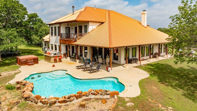 view of pool featuring a patio, a yard, and an outdoor hangout area