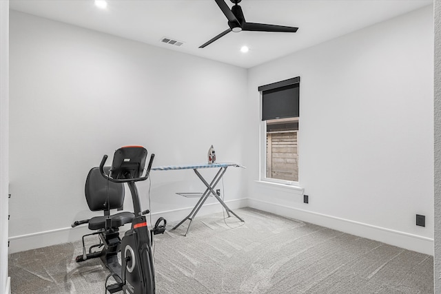 exercise room with ceiling fan and carpet