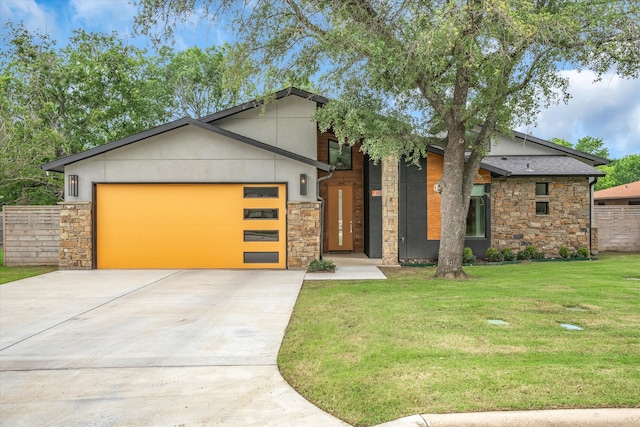 view of front of property featuring a garage and a front lawn