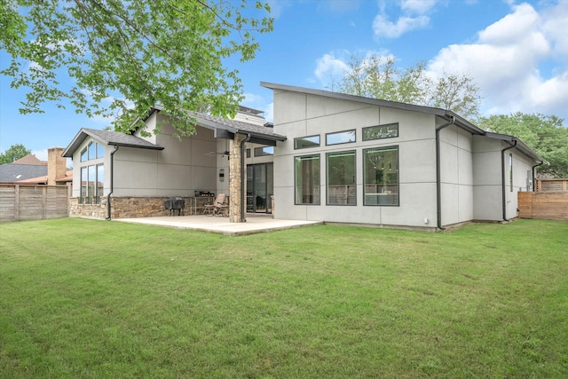 back of property featuring a yard and a patio area