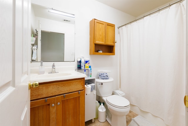 bathroom featuring toilet, tile floors, and vanity