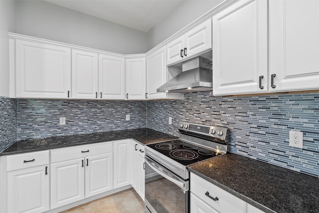 kitchen with white cabinetry, dark stone countertops, stainless steel range with electric stovetop, backsplash, and light tile flooring