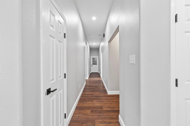 hall with dark wood-type flooring