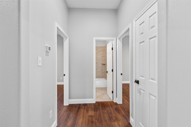 corridor featuring dark wood-type flooring