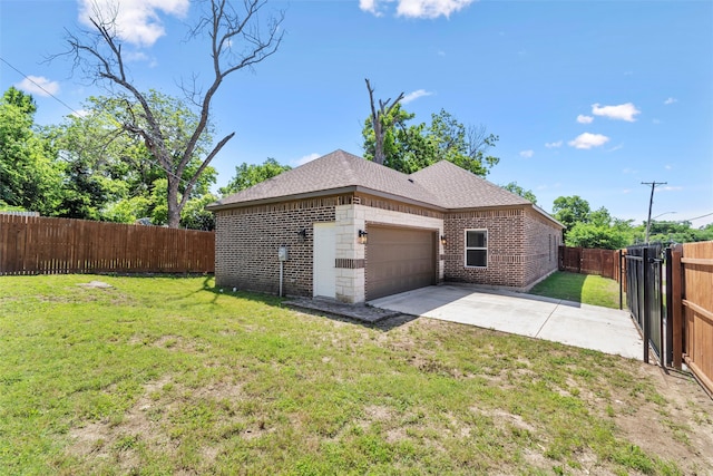 exterior space featuring a garage and a yard