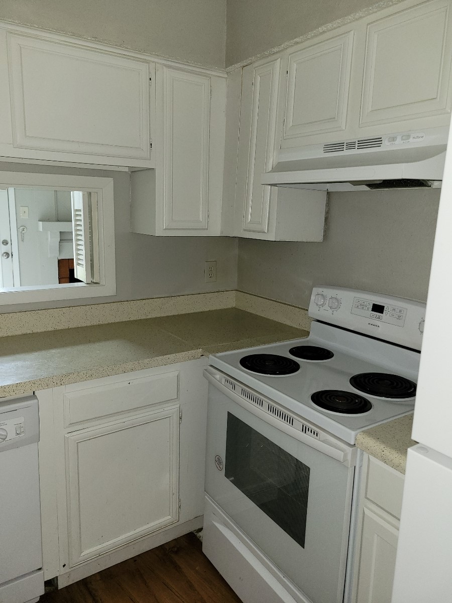 kitchen with white cabinets, white appliances, and dark hardwood / wood-style flooring