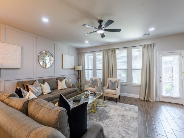 living room featuring wood-type flooring and ceiling fan