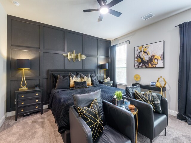 bedroom with light carpet and ceiling fan