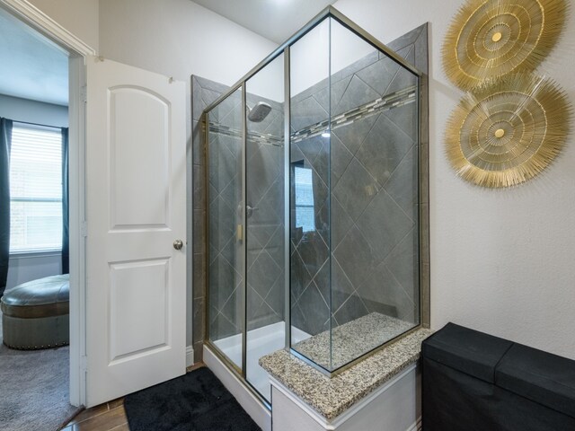 bathroom with a shower with shower door