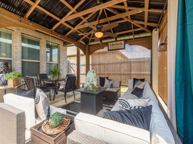 exterior space featuring outdoor lounge area and ceiling fan