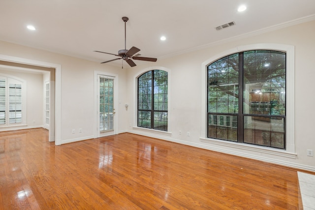 unfurnished room featuring crown molding, hardwood / wood-style flooring, and ceiling fan