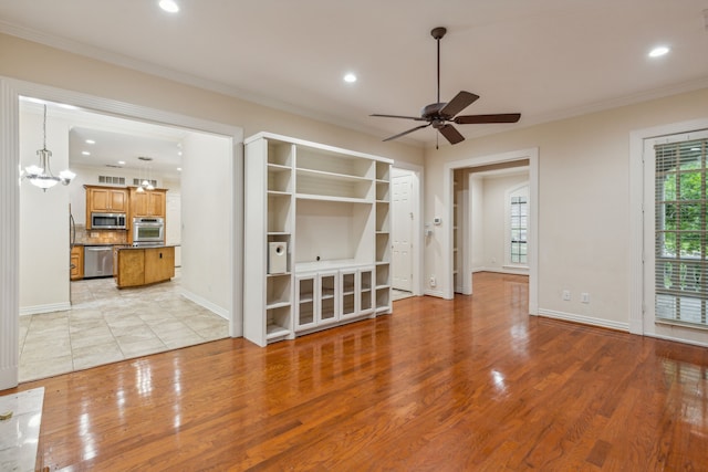 unfurnished living room featuring ornamental molding, light hardwood / wood-style floors, and ceiling fan with notable chandelier