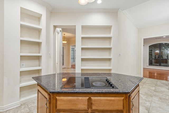 kitchen with dark stone counters, built in features, black electric stovetop, and light tile floors