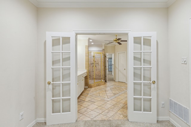 interior space with french doors, crown molding, and light tile flooring