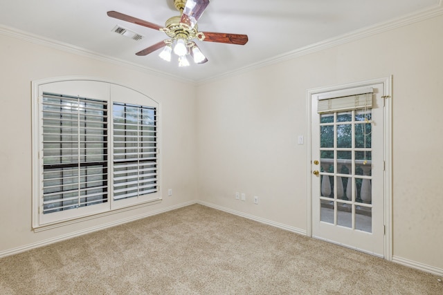 empty room featuring ceiling fan, light colored carpet, and ornamental molding