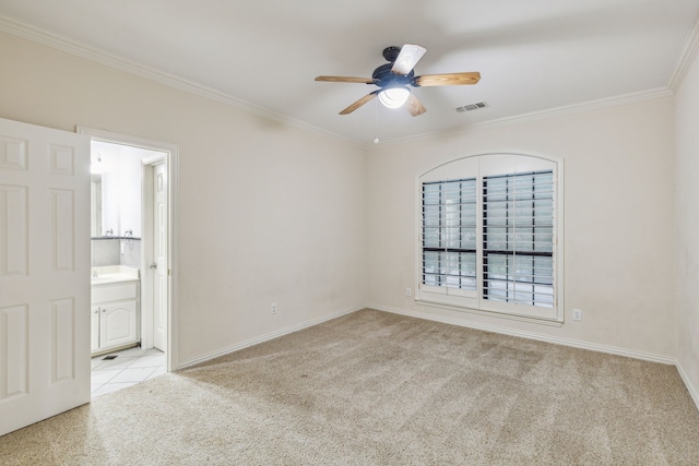 carpeted empty room featuring ceiling fan and crown molding