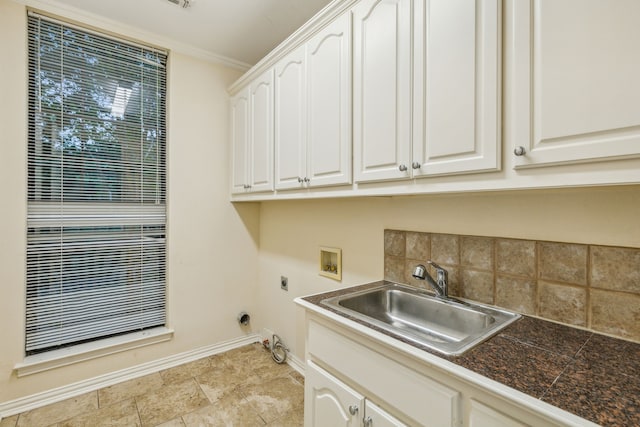 clothes washing area featuring cabinets, electric dryer hookup, crown molding, hookup for a washing machine, and sink