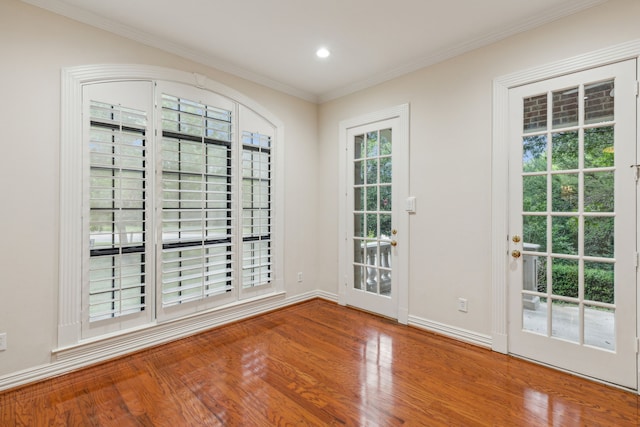 unfurnished room with wood-type flooring and crown molding