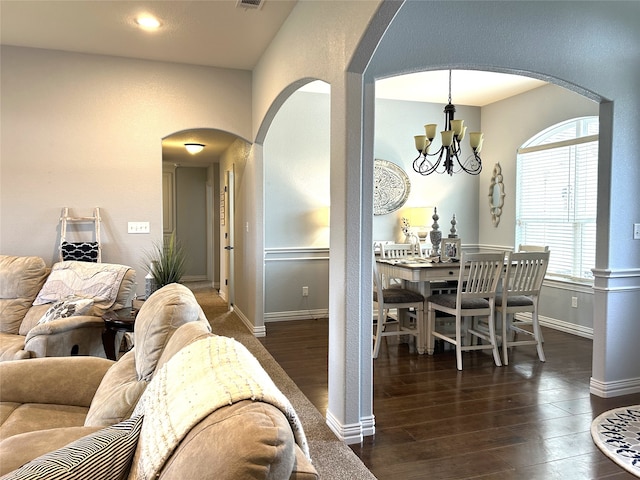 dining room featuring a chandelier and dark wood-type flooring