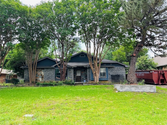 view of front facade with a deck and a front yard