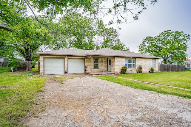 ranch-style home with a front yard and a garage