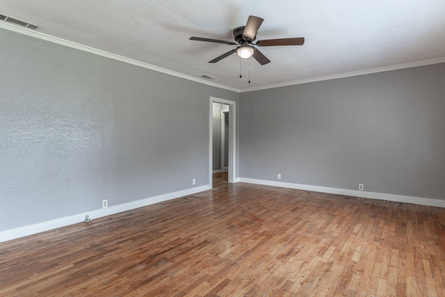 empty room featuring a textured ceiling, hardwood / wood-style floors, ceiling fan, and crown molding