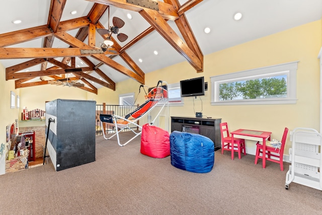 recreation room with carpet flooring, ceiling fan, and vaulted ceiling with beams