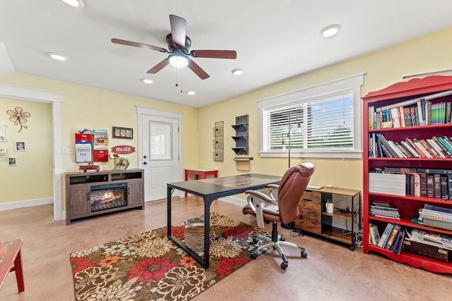 office featuring ceiling fan and light carpet