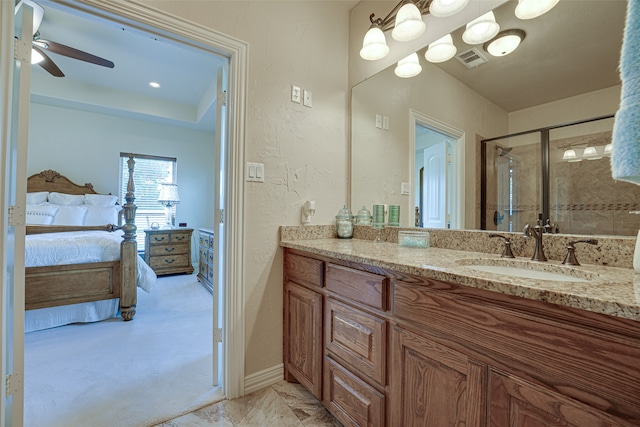 bathroom featuring tile floors, ceiling fan, a raised ceiling, and large vanity