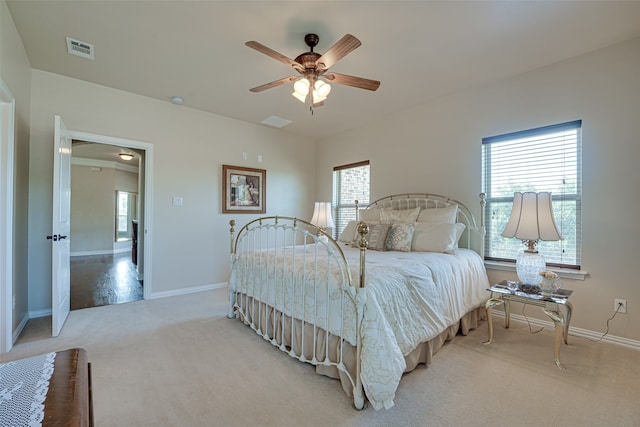 bedroom featuring carpet, ceiling fan, and multiple windows