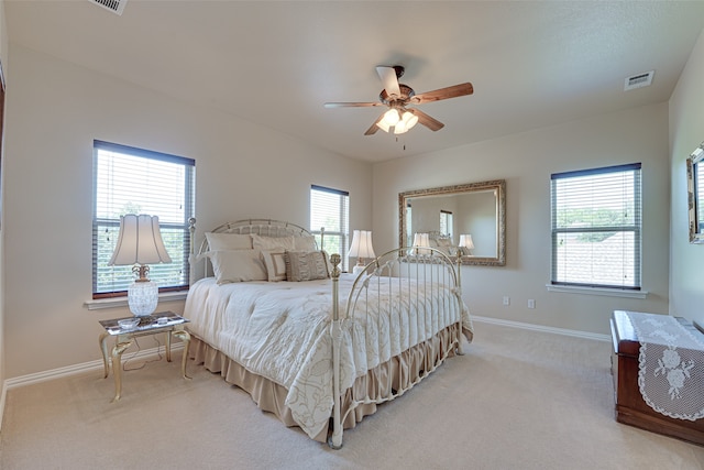 bedroom with multiple windows, carpet flooring, and ceiling fan