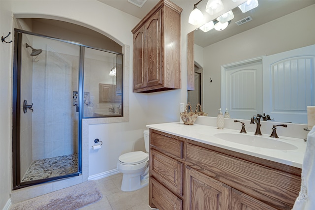 bathroom featuring a shower with shower door, toilet, tile flooring, and vanity