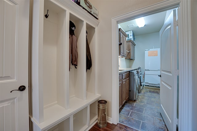 mudroom featuring dark tile floors and washer / clothes dryer