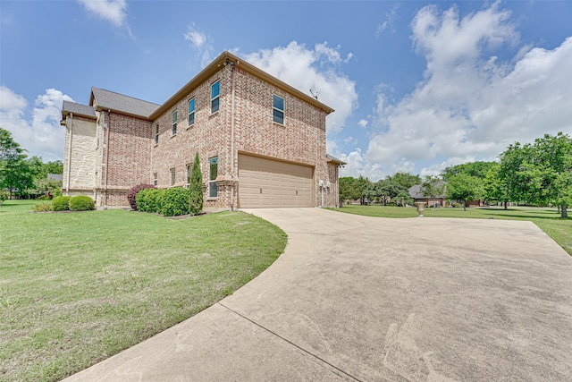 view of front of house featuring a front lawn and a garage