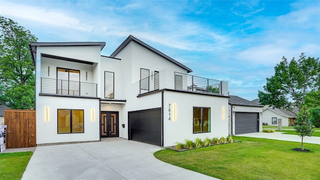 contemporary home featuring a front yard and a balcony