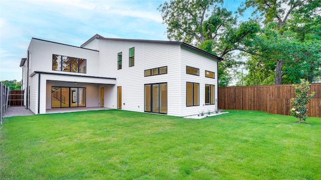 rear view of house featuring a yard