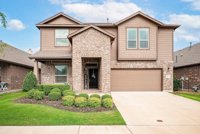 view of front of home featuring a garage, driveway, a front lawn, and brick siding