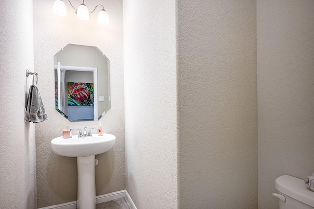 half bathroom featuring toilet