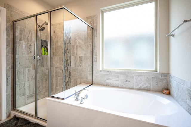 full bathroom with a stall shower and a bath