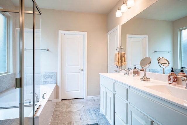 bathroom featuring double vanity, shower with separate bathtub, and tile patterned floors