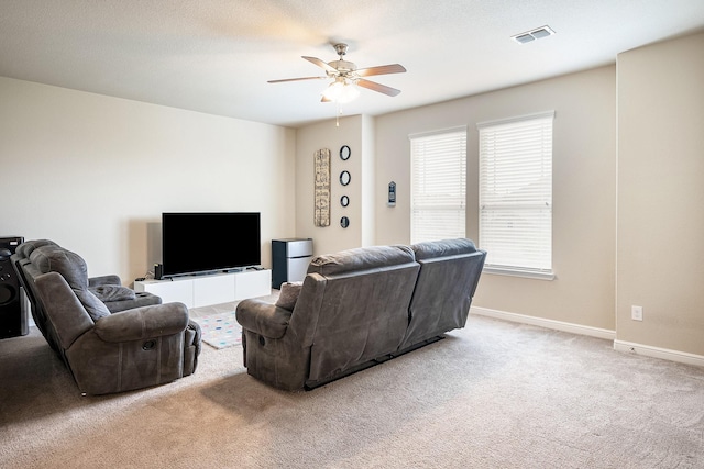living room with baseboards, ceiling fan, carpet, and visible vents