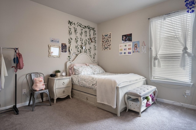 carpeted bedroom featuring baseboards