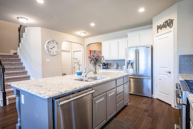 kitchen featuring a sink, white cabinetry, appliances with stainless steel finishes, and dark wood-style floors