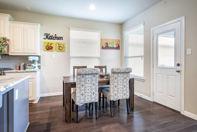 dining space with baseboards and dark wood-style flooring