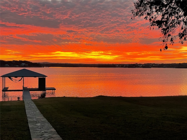 dock area featuring a water view and a lawn