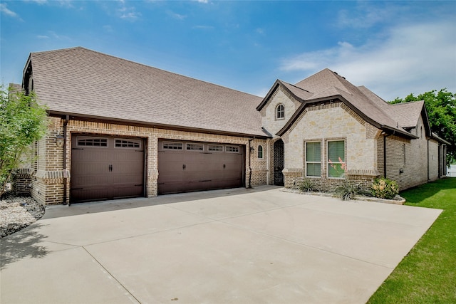 french country home with a garage