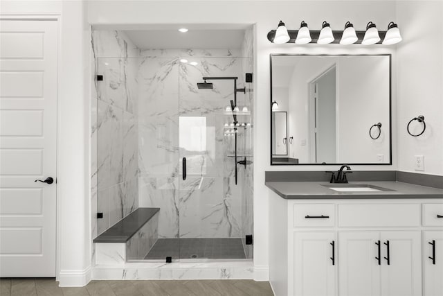 bathroom featuring an enclosed shower and vanity